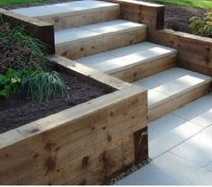 wooden steps leading up to a garden area