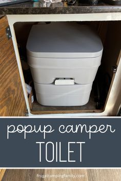 the inside of a camper toilet with text overlay that reads, popup camper toilet