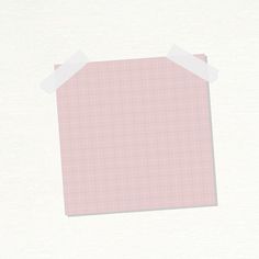 a piece of pink paper with white adhesive tape around it on a plain surface