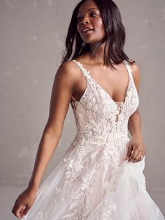 a woman in a white dress posing for the camera