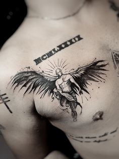 a man with an angel tattoo on his chest