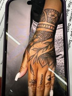 a woman's hand with tattoos on it