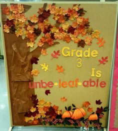 a bulletin board decorated with fall leaves and pumpkins