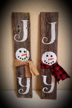 two wooden signs with snowmen painted on them