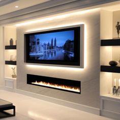 a living room with a large television mounted on the wall above it's fireplace