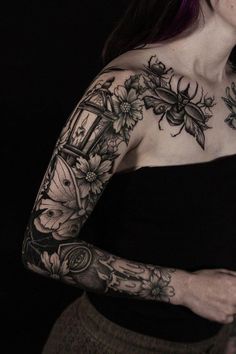 a woman with tattoos on her arm and shoulder