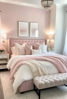 a bedroom with pink walls and white bedding