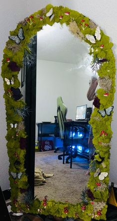 a mirror that is sitting on top of a table in front of a computer desk