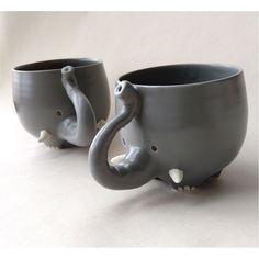 two gray elephant mugs sitting next to each other on top of a white table