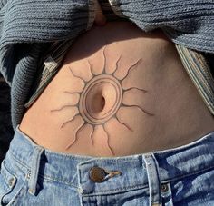 a woman's stomach with a tattoo design on it