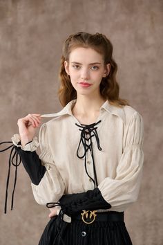 "This shirt from linennaive takes inspiration from the bygone romance and whimsy of sailing. very inch exudes a carefree spirit It's cut from soft linen in a relaxed silhouette and has contrast sleeves to make it stand out. Elegant ruffle details add drama to this piece, making it effortless and romantic. Contrasting lace-up detailing at front - feel free to tie it in a bow for a playful feel. This shirt creates an effortlessly cool look without any styling on your end. Pull it on and enjoy your day. 【Fabric】 100% linen, around 220g/gram exquisite high end texture. 【Size】 Based on approximate body measurements. *SIZE XS (US 0-2 | UK/AU 4-6 | DE 32-34 | FR 34-36 | IT 38-40 | RU 40-42 | JP 7-9) bust: 32.5\"-33.5\" / 81-85 cm *SIZE S (US 4-6 | UK/AU 8-10 | DE 34-36 | FR 36-38 | IT 40-42 | RU Victorian Shirt, Poet Shirt, Hooded Wool Coat, Laced Up Shirt, Floral Corset, Anne With An E, Cooler Look, Check Dress, Linen Blouse