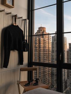 a bedroom with a view of skyscrapers and high rise buildings from the window sill