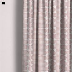 a pink curtain hanging on the side of a wall