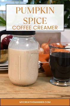 pumpkin spice coffee creamer in a mason jar next to a cup of coffee on a table