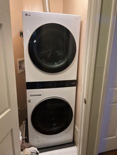 a washer and dryer stacked on top of each other in a small room