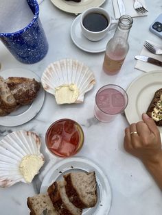 a table topped with plates of food and drinks