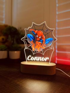 a spider - man lamp with the name connor on it