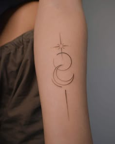 a woman's arm with a cross and star tattoo on the left side of her arm