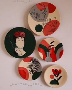 four plates with different designs on them