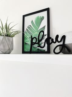 there is a plant on the shelf next to a sign that says plesy