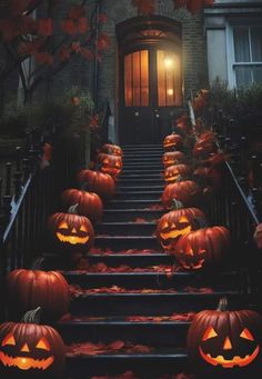 halloween pumpkins on the steps in front of a house with an entrance lit up