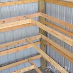 the inside of a building with metal and wood slats