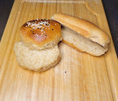 two loaves of bread sitting on top of a cutting board next to each other