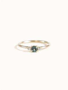 A classic teal blue green three-stone Sapphire ring with diamond accents. Dainty Wedding Ring Green, Blue Green Ring, Small Vintage Engagement Rings, Boho Wedding Rings, Sapphire Ring Simple, Green Gem Ring, Small Engagement Ring, Mens Engagement Rings, Blue Green Sapphire Engagement Ring