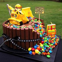 a birthday cake made to look like a construction truck with lots of candy on it