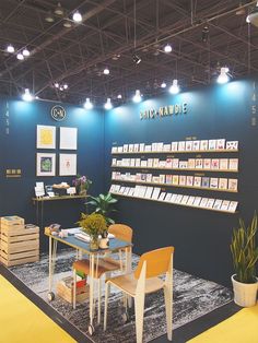 a room filled with lots of furniture and decor on display in front of a sign that says ship - made