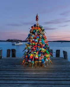 a brightly colored christmas tree on a dock