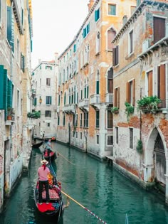 two gondolas are tied to the side of buildings on a canal in venice