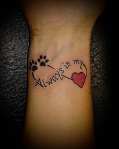 a dog paw and heart tattoo with the words always in my heart written on it