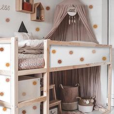 a child's bed with a canopy over it and rainbows on the wall