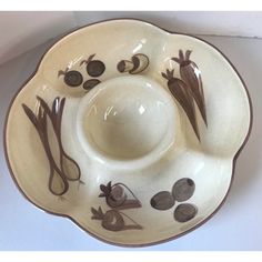 a white bowl with brown designs on it