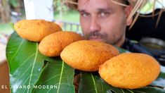 a man is looking at some food on a leaf