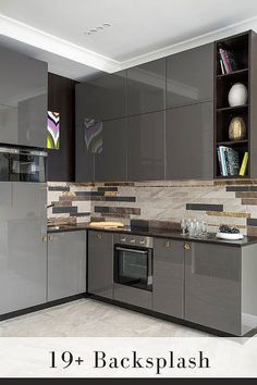 a kitchen with gray cabinets and marble counter tops