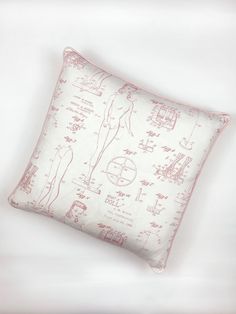 a white pillow with pink drawings on it