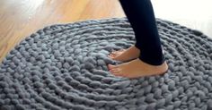 a person standing on top of a gray rug