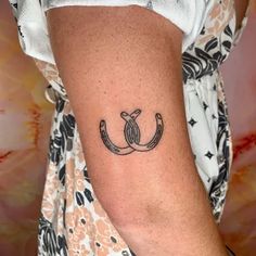 a woman's arm with an anchor tattoo on the left side of her arm