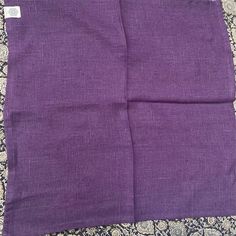 two pieces of purple fabric sitting on top of a table