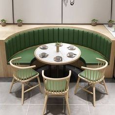 a table with four chairs around it in the middle of a room that looks like a booth