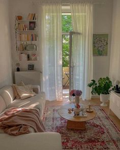 a living room filled with furniture and lots of windows