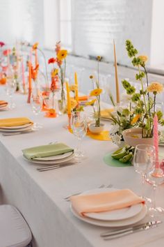 a long table is set with plates and place settings