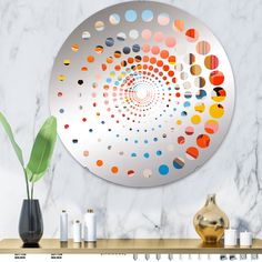 a round metal plate with multicolored circles on it next to some vases