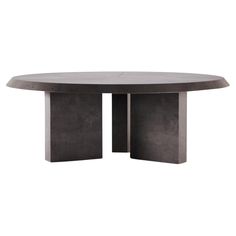 an oval table with two pedestals on the top and one in grey concrete, against a white background