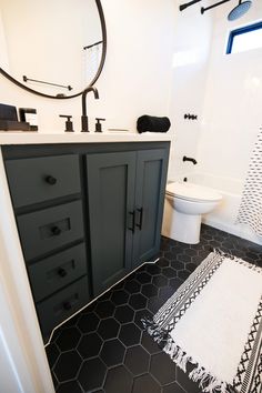 a bathroom with black and white tile flooring