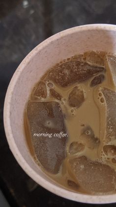 a cup filled with liquid and ice on top of a table