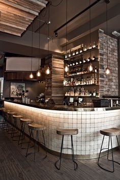 a bar with several stools in front of it