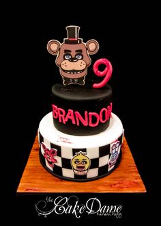 a three tiered cake with a monkey on top